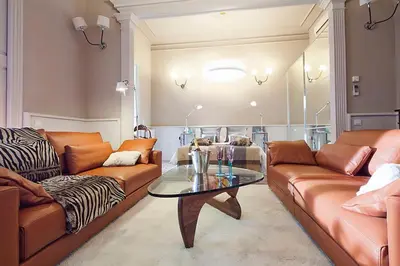 a living room with two couches and a glass table at My Space Emirates - Apartments in Rambla de Catalunya in Barcelona
