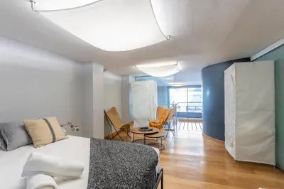 a bedroom with a bed and a table and chairs at My Space Emirates - Bright Apartment in Gracia with shared Pool in Barcelona