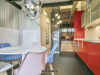 a kitchen with a white table and blue chairs at Alcam Futbol Pequeño in Barcelona