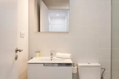 a white bathroom with a sink and a toilet at 2512 - AB Comte dUrgell P-II in Barcelona