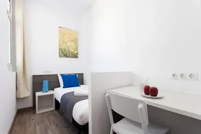 a white room with a bed and a desk with apples on it at 2513 - AB Comte dUrgell II-I in Barcelona