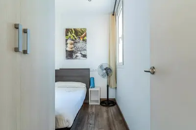 a bedroom with a bed and a window and a door at 2514 - AB Comte dUrgell V-II in Barcelona