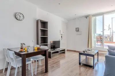 a white living room with a table and a dining room at 2514 - AB Comte dUrgell V-II in Barcelona