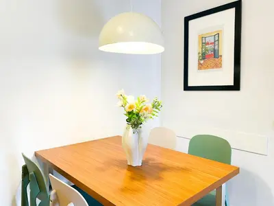 a vase of flowers sitting on a wooden table at Boutique Pare Lainez in Barcelona