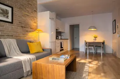 a living room with a couch and a table at Boutique Pare Lainez in Barcelona