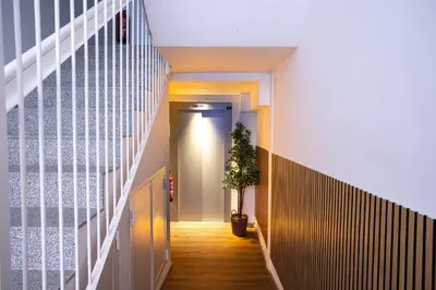 a hallway with a potted plant on the floor at StayCampNou Studio with Balcony in Hospitalet de Llobregat