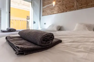 a towel is sitting on top of a bed at Apartamento La Boqueria 3 in Barcelona