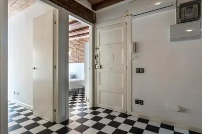 a room with a door and a checkered floor at Apartamento La Boqueria 3 in Barcelona