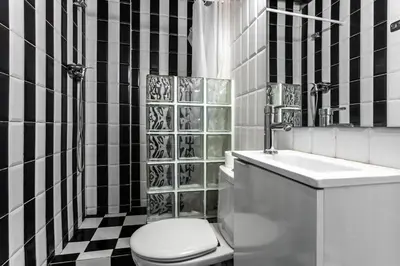 a black and white bathroom with a toilet and a sink at Apartamento La Boqueria 3 in Barcelona