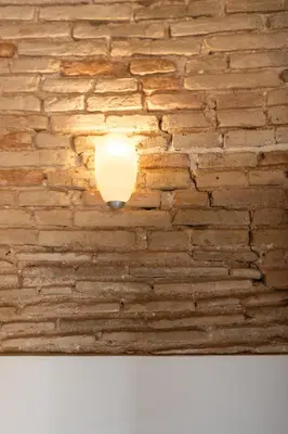 a light fixture on a brick wall at Apartamento La Boqueria 3 in Barcelona