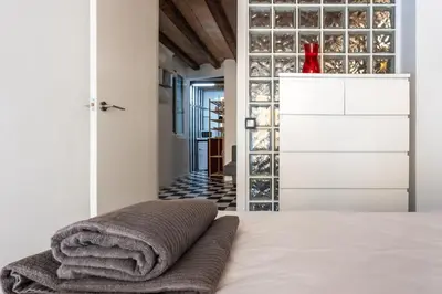 a bedroom with a bed with towels on it at Apartamento La Boqueria 3 in Barcelona