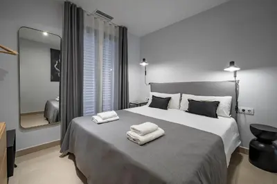 a bedroom with a large bed with two towels on it at Habitat Apartments Free Jazz in Barcelona