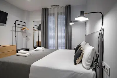 a bedroom with a large bed with two mirrors at Habitat Apartments Free Jazz in Barcelona