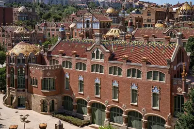 an old red brick building with a city in the background at Habitat Apartments Free Jazz in Barcelona