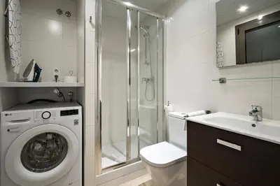 a bathroom with a washing machine and a sink at Habitat Apartments Free Jazz in Barcelona