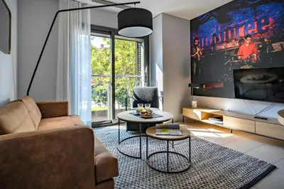 a living room with a couch and a tv at Habitat Apartments Free Jazz in Barcelona