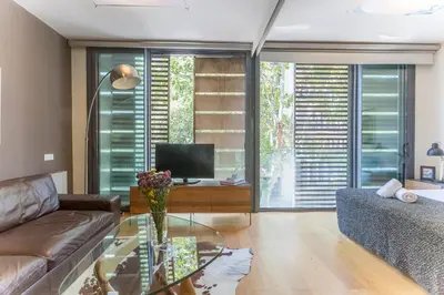 a living room with a couch and a glass table at My Space Emirates - Fully equipped apartments near the Beach with shared pool in Barcelona