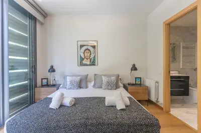 a bedroom with a large bed with white pillows at My Space Emirates - Fully equipped apartments near the Beach with shared pool in Barcelona
