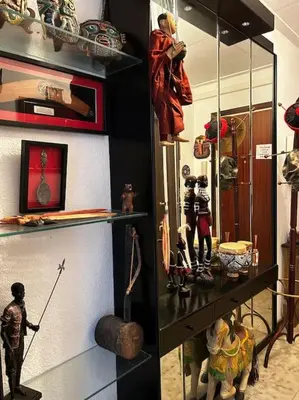 a room with a shelf with figurines on it at Apartamento a primera línea de Mar in Pineda de Mar