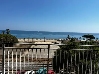 a view of a beach and the ocean from a balcony at Apartamento a primera línea de Mar in Pineda de Mar