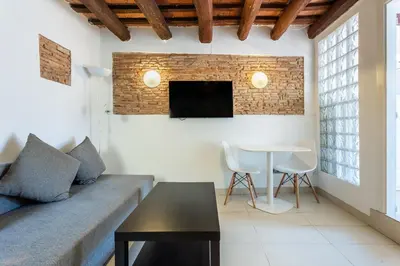 a living room with a couch and a table at Apartamento La boqueria Atic in Barcelona