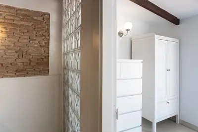 a room with a brick wall and a white closet at Apartamento La boqueria Atic in Barcelona