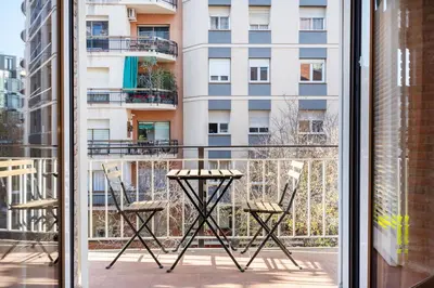a balcony with two chairs and a table at Warmth and comfort in the sought-after Eixample in Barcelona