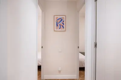 a hallway with a mirror and a picture on the wall at Warmth and comfort in the sought-after Eixample in Barcelona