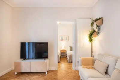 a living room with a tv and a couch at Warmth and comfort in the sought-after Eixample in Barcelona