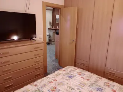 a bedroom with a bed and a flat screen tv at Casa en Barcelona in Papiol