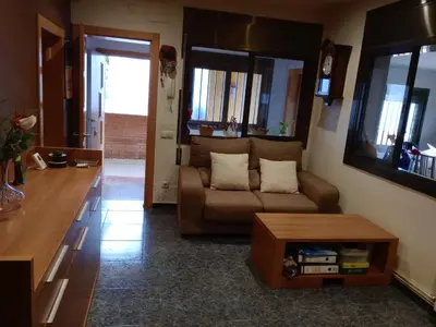 a living room with a couch and a table at Casa en Barcelona in Papiol