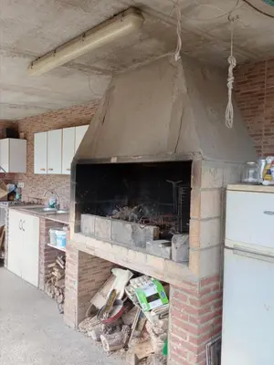 a kitchen with a brick oven in a room at Casa en Barcelona in Papiol