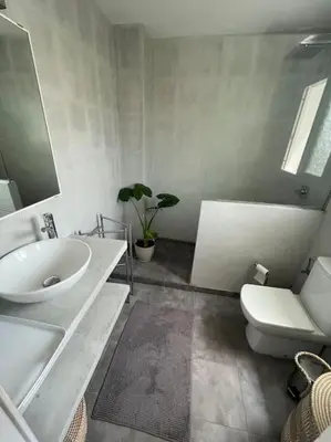 a bathroom with a sink and a toilet and a mirror at Preciosa casa en el centro con terraza y patio in Sitges