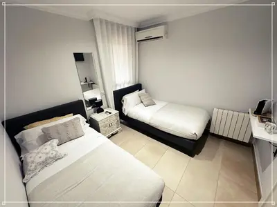 a small room with two beds in it at FIRA GRAN VIA II in Hospitalet de Llobregat