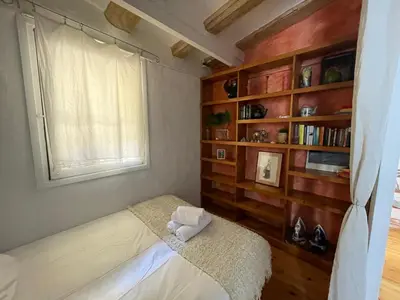 a bedroom with a bed and a book shelf at Original duplex in the center of Barcelona in Barcelona