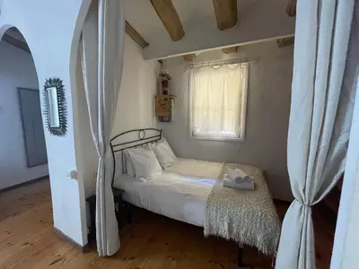 a small bedroom with a bed and a window at Original duplex in the center of Barcelona in Barcelona