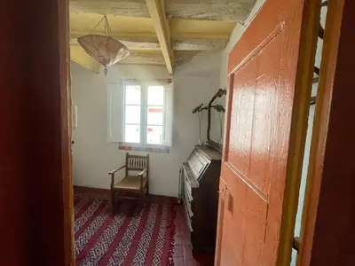 a hallway with a window and a chair in a room at Original duplex in the center of Barcelona in Barcelona