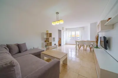 a living room with a couch and a table at HomeHolidaysRentals Anais - Costa Barcelona in Pineda de Mar