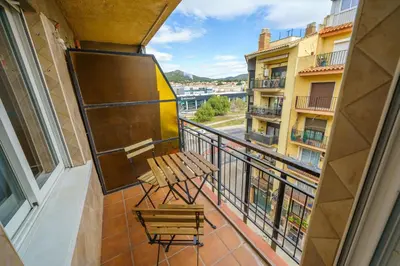 a balcony with a bench and a view of a city at HomeHolidaysRentals Anais - Costa Barcelona in Pineda de Mar