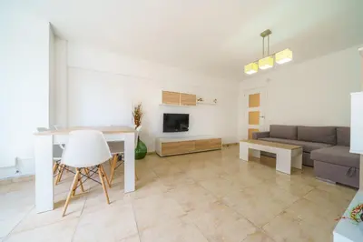 a living room with a couch and a table at HomeHolidaysRentals Anais - Costa Barcelona in Pineda de Mar