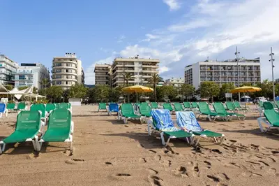 a row of chairs and umbrellas on a beach at Holiday home in Calella de la Costa 3641 in Calella