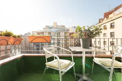a table and chairs on a balcony with a view at Eulalias Lodges Barcelona in Barcelona