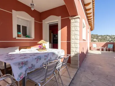 a table and chairs on a patio with a table and a balcony at Holiday Home Villa Rosales by Interhome in Gornal