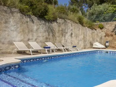 a group of chairs and a swimming pool at Holiday Home Villa Rosales by Interhome in Gornal
