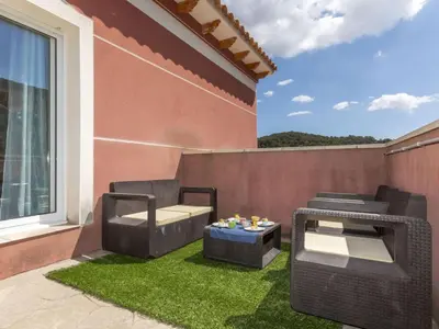 a patio with two chairs and a table on the grass at Holiday Home Villa Rosales by Interhome in Gornal