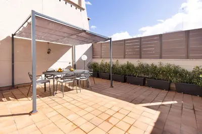 a patio with a table and chairs under a canopy at Enjoy Apartments Calle Paris Super Stylish in Barcelona