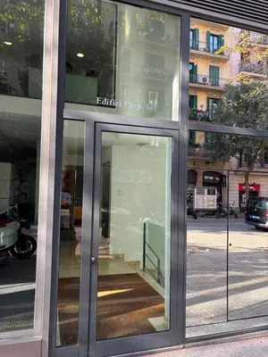 a glass door of a building on a city street at Enjoy Apartments Calle Paris Super Stylish in Barcelona