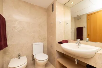 a bathroom with a sink and a toilet and a mirror at Enjoy Apartments Calle Paris Super Stylish in Barcelona