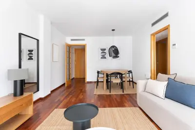 a living room with a white couch and a table at Enjoy Apartments Calle Paris Super Stylish in Barcelona