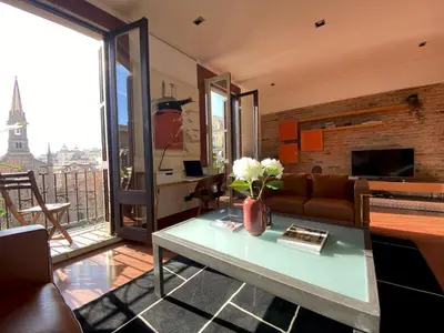 a living room with a couch and a table at Luminous Designer Loft Style Apt Eixample Views By MyRentalHost in Barcelona